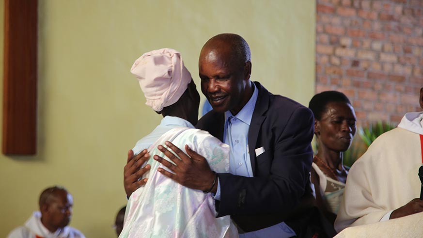 Gaspard  Ntakavuro one of genocide convicts hugging a genocide survivor  who forgave himfor his role in killing her family members.jean d'Amour Mbonyinshuti