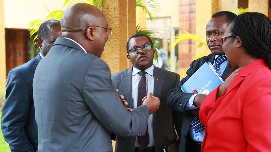 Prime Minister Edouard Ngirente chats with other ministers after his presentation yesterday (Sam Ngendahimana)