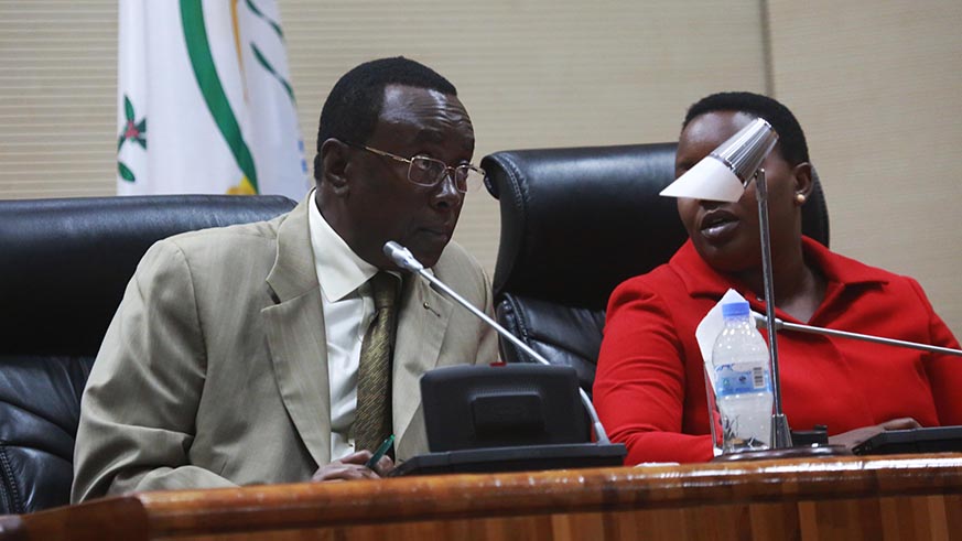 Senate President Bernard Makuza chats with Vice President of Lower chamber during the session
