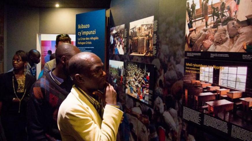 Visitors study Rwandau2019s tragic history at Kigali Genocide memorial. File