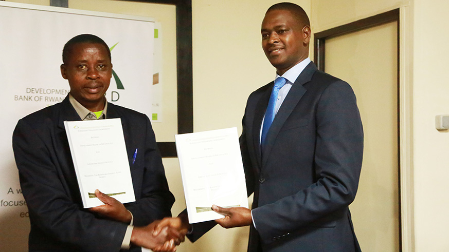 Rutabana (right) and some of the SACCO leaders at the signing ceremony in Kigali yesterday. / Sam Ngendahimana.