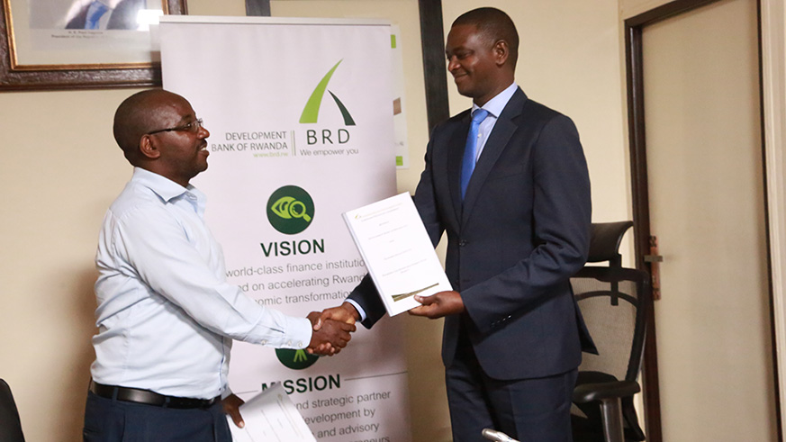 Rutabana (right) and some of the SACCO leaders at the signing ceremony in Kigali yesterday. / Sam Ngendahimana.