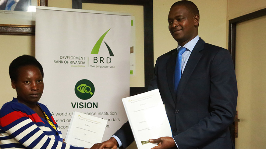 Rutabana (right) and some of the SACCO leaders at the signing ceremony in Kigali yesterday. / Sam Ngendahimana.