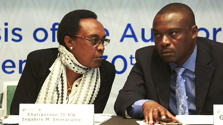 Transparence International Rwanda Marie Immaculee Ingabire chats with Clement Musangabatware  Deputy Ombudsman in charge of preventing and fighting corruption  during the meeting (Sam Ngendahimana)