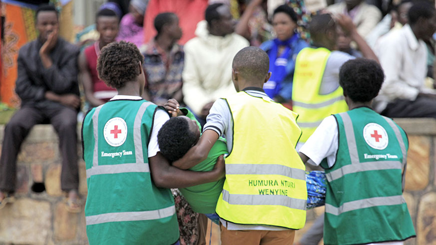Volunteers carry a trauma victim during a commemoration event at Murambi Genocide Memorial last year.  Sam Ngendahimana