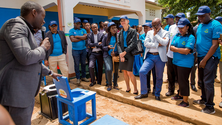 Emmanuel Tuyisenge, Managing Director of TEMACO Builders, shows guests various locally available latrine technologies, including latrines designed for people with disabilities.