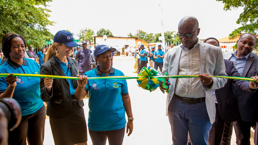 Sheikh Hassan Bahame, Director General in charge of social affairs and community development at the Ministry of Local Governmen cuts the ribbon at the inauguration of Rwamagana District Sanitation Centre. Looking on are (right to left) Jeanne Umutoni,  Vice Mayor of Rwamagana District in charge of social affairs; Leslie Marbury, USAID Acting Mission Director; and Phomolo Maphosa, SNV Rwanda Country Director. All photos/Courtesy.