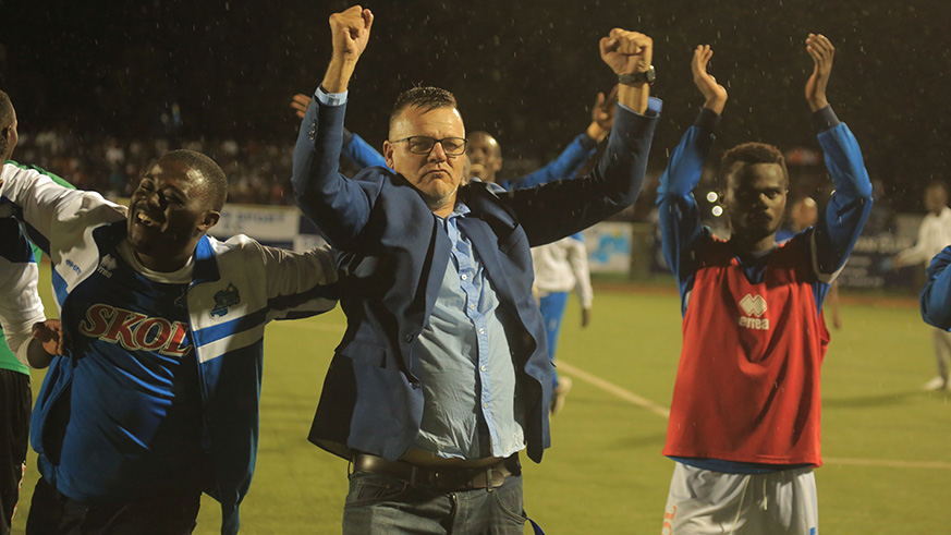 Coach Ivan Minnaert (M) and Rayon Sports players gesture after defeating Mozambican side Costa Do Sol 3-0. Minnaert says the team will not sit back and defend in the return leg. Samuel Ngendahimana