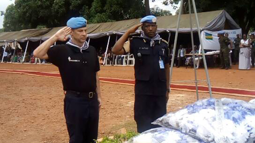 MINUSCA Police Commissioner, Roland Zamora and ACP Emmanuel Hatari, the commander of Rwandan peacekeepers in CAR salute after laying wreath to pay tribute to Genocide victims. / Courtesy