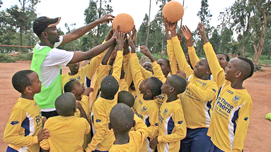 Eugene Murangwa with Dream Team Football Academy youngsters in Kigali in the past. The former goalkeeper says he survived the Genocide against the Tutsi partly because he was a footballer. Courtesy.