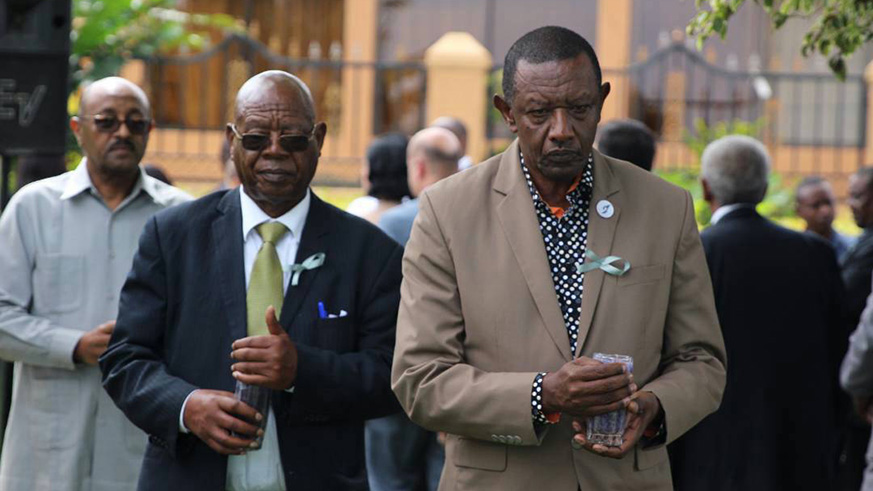 Ugandau2019s State Minister for Regional Cooperation, Philemon Mateke (L), and Rwandau2019s High Commissioner to Uganda Frank Mugambage (R), lead mourners in a candle lighting session during the 24th commemoration of the Genocide against the Tutsi in Entebbe, Uganda. Gashegu Muramira