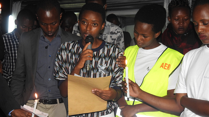 A second year student in mining at the University of Rwandau2019s College of Science and Technology, Yvonne Umuhoza,  reading a letter to her late parents she never saw. (Frederic Byumvuhore)