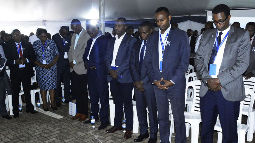 Employees of Rwanda Revenue Authority, National Electoral Commission and Office of Auditor General observe a moment of silence to honour Genocide victims. Sam Ngendahimana.
