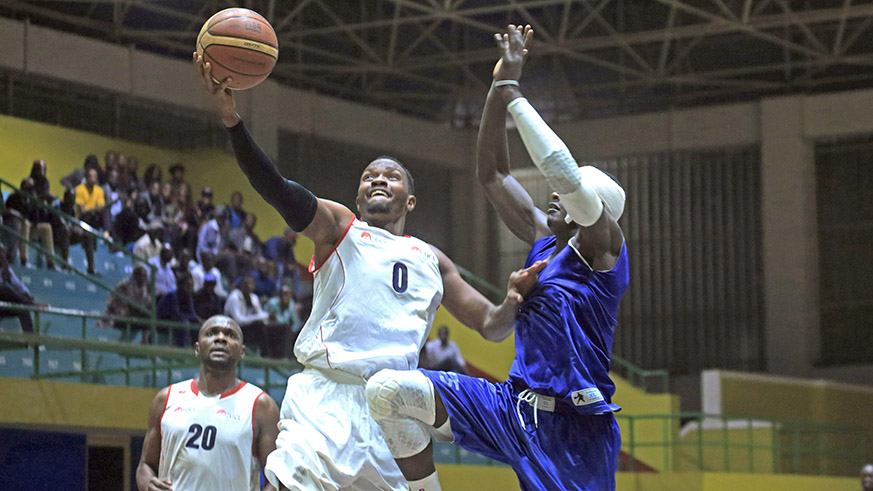 REGu2019s Walter Chris Nkurunziza finishes off a stylish lay-up during a game against Espoir in the league.  Sam Ngendahimana.
