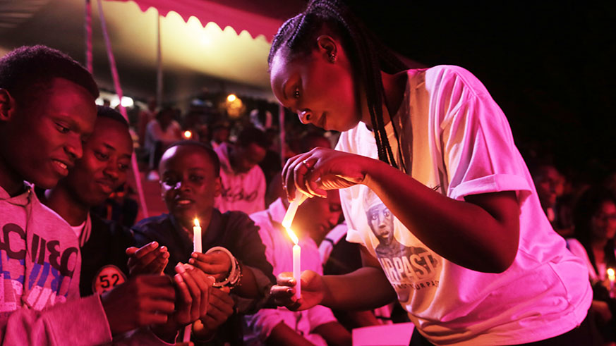 Youth light candles  at the Kigali Genocide Memorial on Monday. 