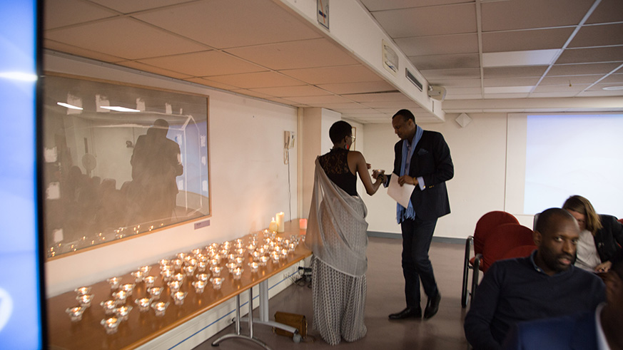 Rwandan ambassador to France, Jacques Kabale, receives a burning candle during the  24th commemoration of the 1994 Genocide against the Tutsi. (Courtesy photos)