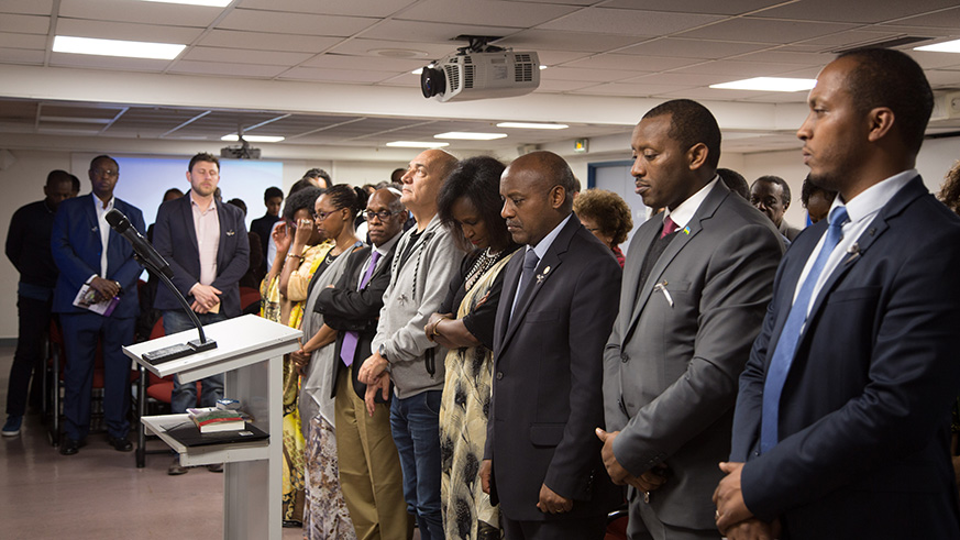 Rwandan ambassador to France, Jacques Kabale, receives a burning candle during the  24th commemoration of the 1994 Genocide against the Tutsi. (Courtesy photos)