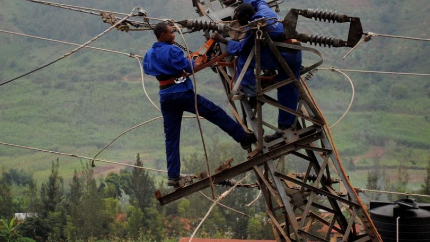 Rwanda Energy Group workers fix electric cables. File.