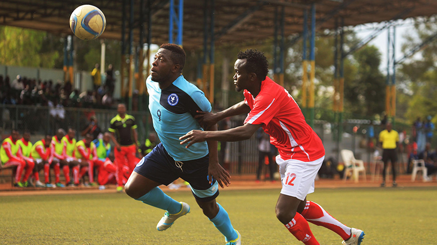 Police FC striker Isae Songa (left) and Musanzeu2019s Moses Kanamugire vie for the ball during a Peace Cup tie earlier this month at Kicukiro Stadium. File