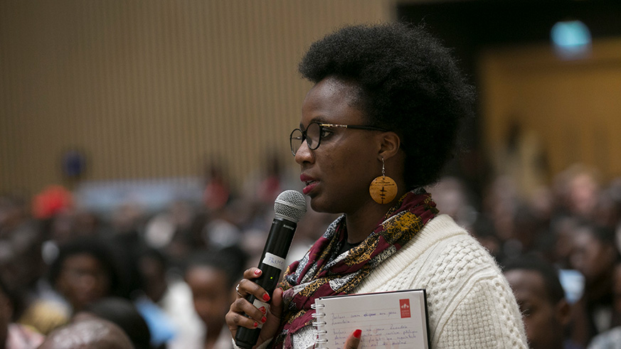 A participant asks a question during a Q and A session with the author