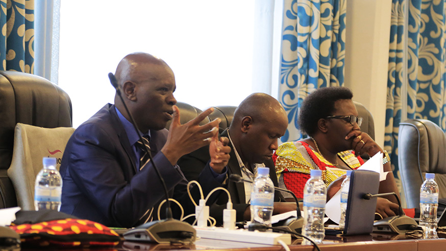 PAC deputy chairperson Karenzi  (L) poses a question as other PMs look on during the meeting with Minister Uwizeye yesterday. Sam Ngendahimana. 