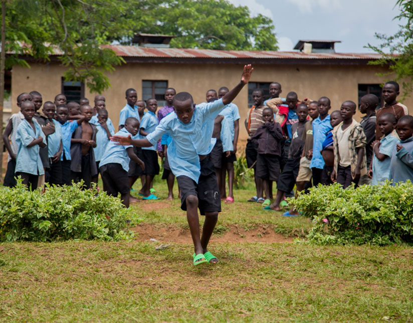 A child tries out a somersault.  