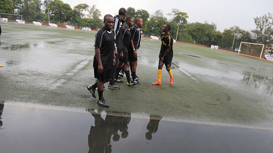 Referees observe the pitch before postponing the league match between Police FC and Mukura at Kigali Stadium today (Sam Ngendahimana)