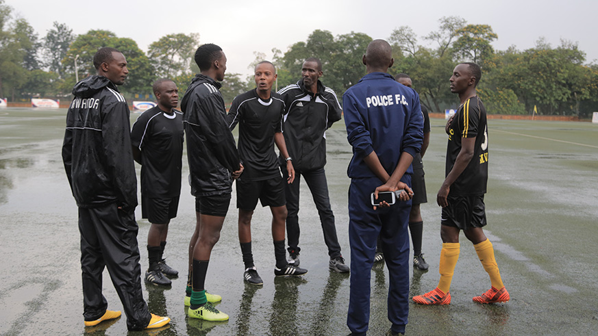 Referees observe the pitch before postponing the league match between Police FC and Mukura at Kigali Stadium today (Sam Ngendahimana)