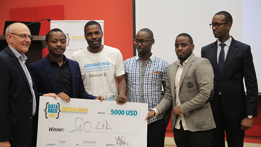 Winners of Data Hack 4FI Innovation Award pose with officials to receive after receiving their cheque of 5000 US $ in Kigali (Sam Ngendahimana)