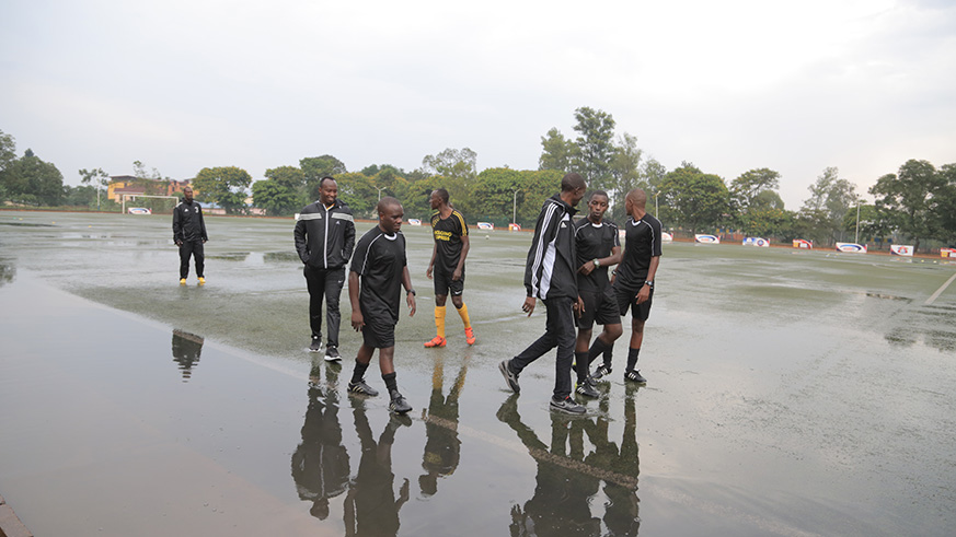 Referees observe the pitch before postponing the league match between Police FC and Mukura at Kigali Stadium today (Sam Ngendahimana)