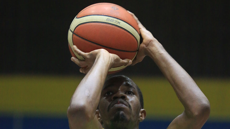 A UGB player takes a throw in a league match against APR at Amahoro indoor stadium. 