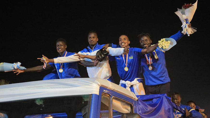 Rayon Sports players celebrate after arriving in the country yesterday. Sam Ngendahimana.