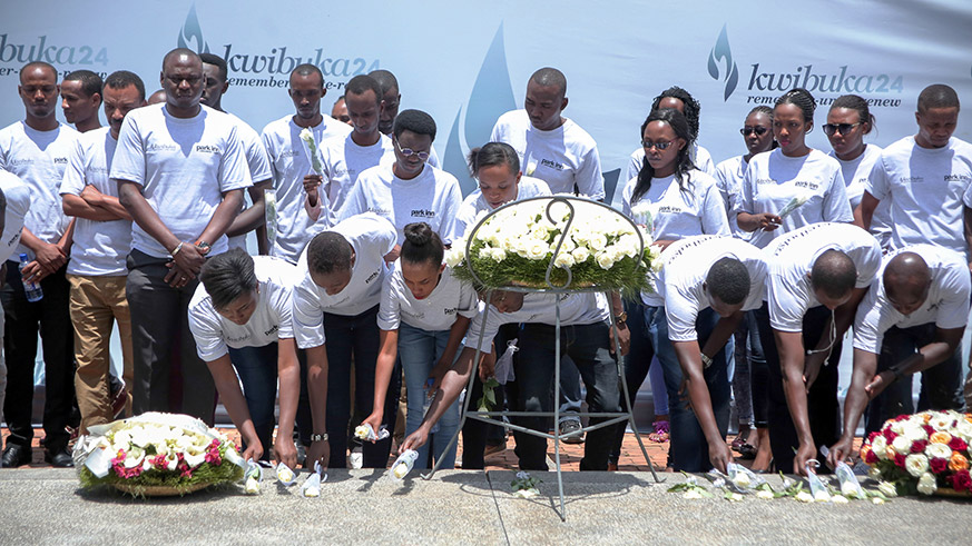 Park Inn by Radisson staff laying a wreath on a mass grave at Kigali Genocide Memorial.