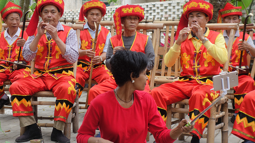 Li men enjoy playing unique music instruments made  from coconut among other materials.