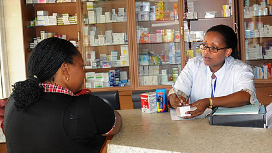 A pharmacist attends to a client. File.