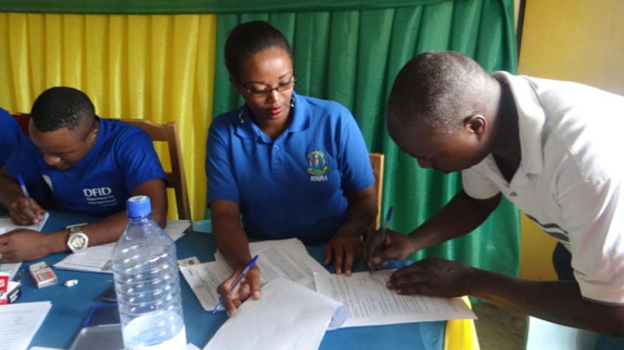 Land registration officers help Kamonyi residents register their property. (File)