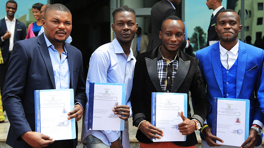 L-R: Marcel Lomami, Andre Lomami, Jimmy Kibengo and Peter Otemma with their citizenship certificates at City Hall yesterday. Sam Ngendahimana.