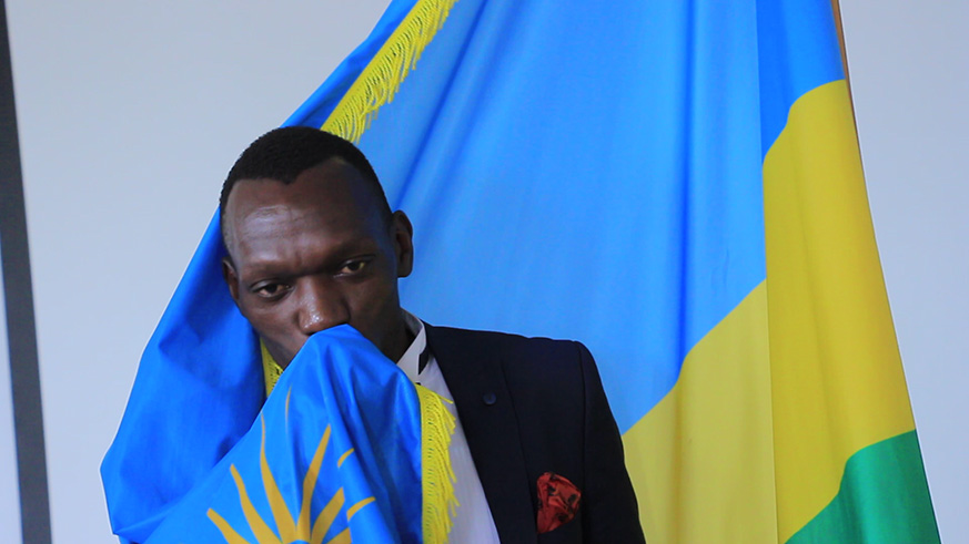 Kagere kisses the national flag after becoming Rwandan.
