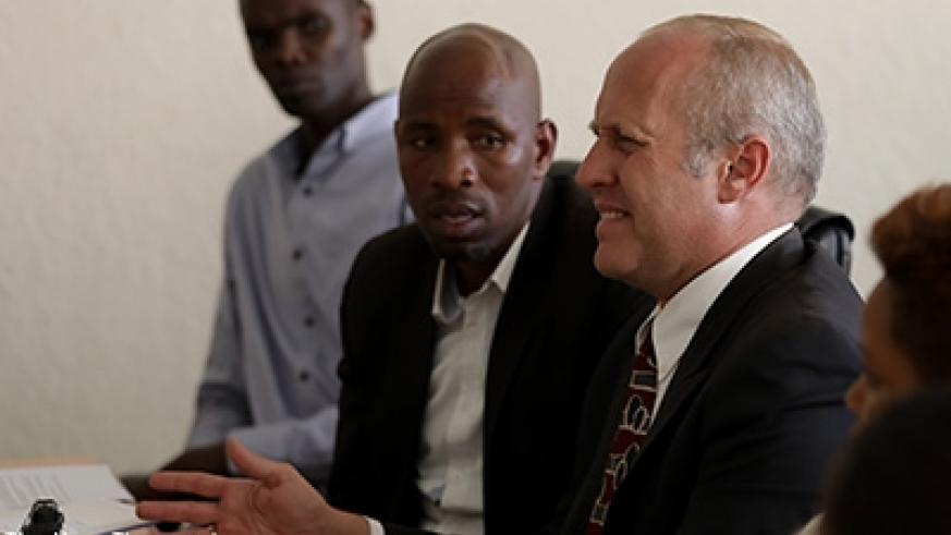 Amazing Grace Radio proprietor (right) Gregory Ryan Shoof explains himself before Rwanda Media Commission in February 2018. File.
