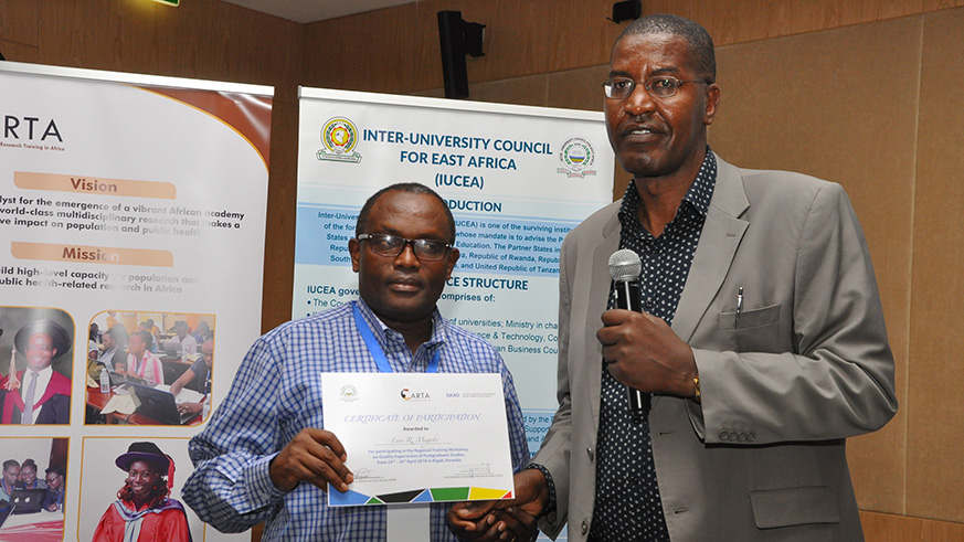 Prof. Peter Ngure, the programme manager Consortium for Advanced Research Training in Africa (CARTA), hands over a certificate to Dr Lu00e9on Mugabo, a lecturer at the University of Rwanda in Kigali this week. Courtesy.
