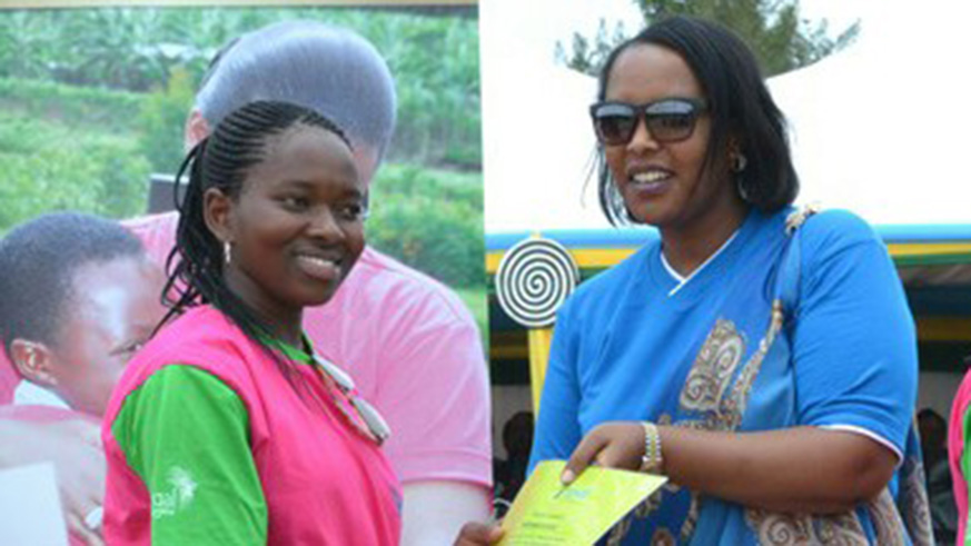 Louise Kanyange (L) receives an award for her excellent performanace in TVET last year. The awards were given by  Imbuto Foundation. Courtesy.