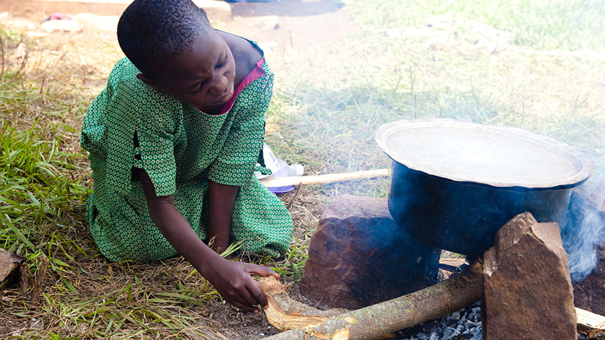 A girl cooks using firewood. (File)
