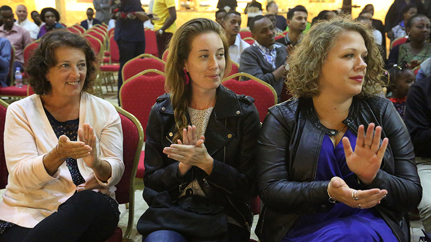 Participants applaud after watching the Royal Tour at Kigali Cultural village on Saturday (Sam Ngendahimana)