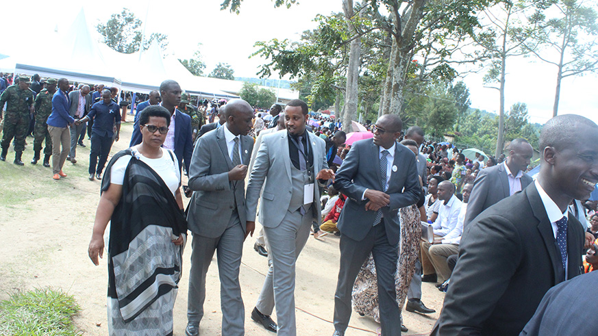 Minister Kaboneka (second left) and other officials heading to the mass grave where over 120bodies were burried. Jean d'Amour MBonyinshuti