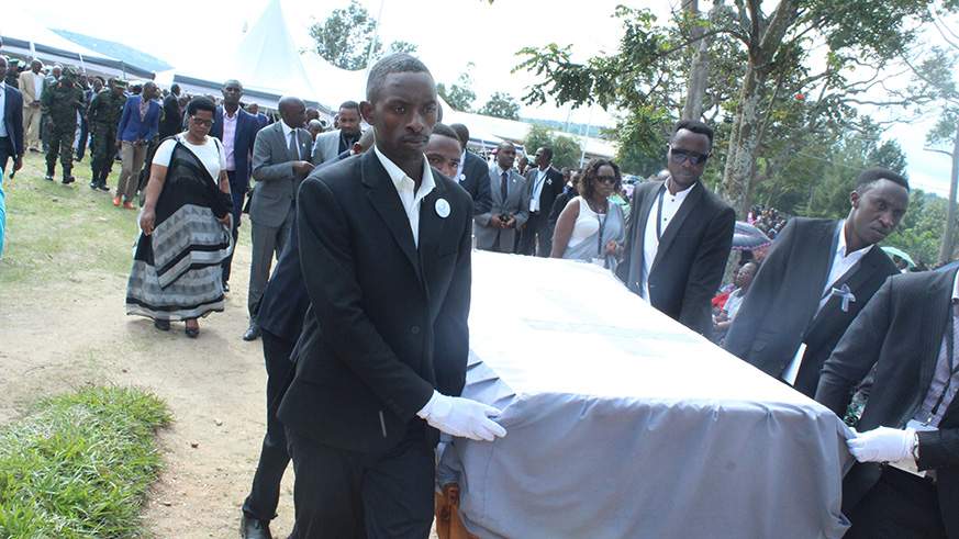 Mourners carry a coffin containing remains of Genocide victims.