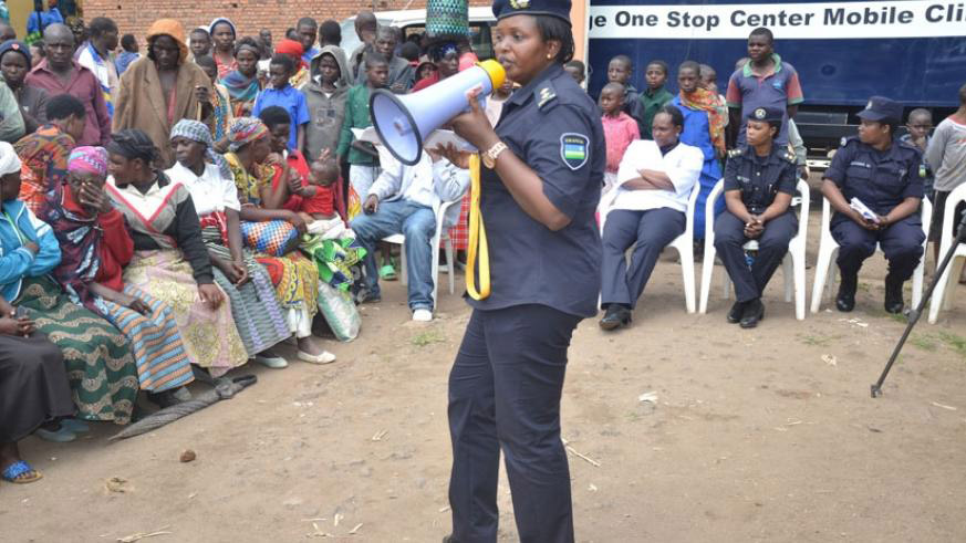 A Police officer sensitises Musanze residents about gender based violence. The Isange Mobile Clinic is one of the initiatives government has put in place to help in the fight against gender based violence . File.