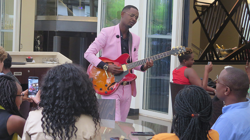 Burundian guitarist Andy Mwanga joins the audience during performance- Edie Nsabimana