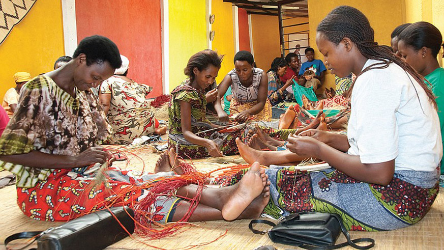 Members of the Gahaya Links Cooperative at their Kigali workshop weaving baskets. Net.