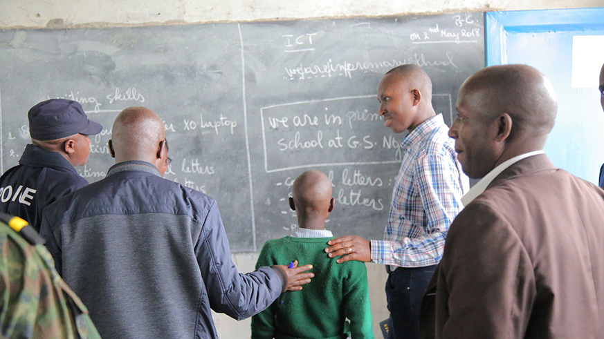 Officials listen to the fluency of a pupil from G.S Nganzo in Gakenke District. Regis Umurengezi.