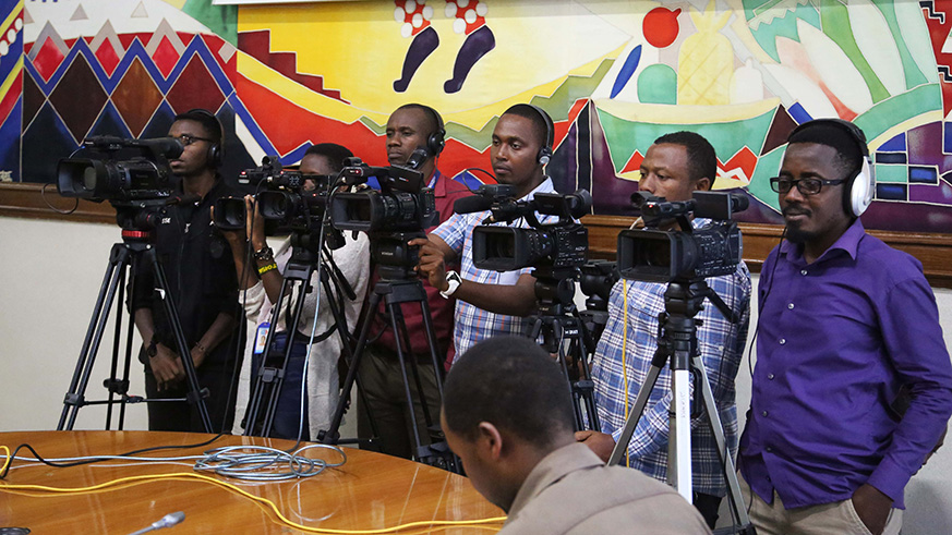 Journalists follow  Marie-Solange Kayisire, the Minister for Cabinet Affairs as she speaks to them during the conference .Sam Ngendahimana